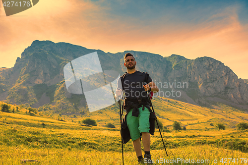 Image of Man Hiking in Green Mountains