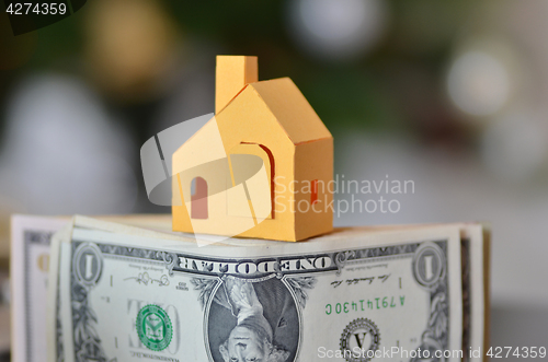 Image of Miniature paper made house stand on  money