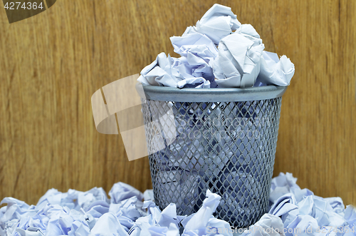 Image of Garbage bin with paper waste