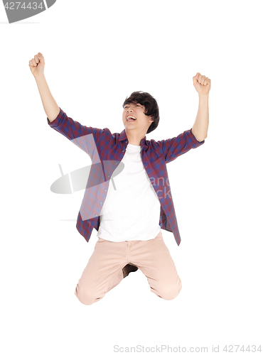 Image of Happy man kneeling on floor.