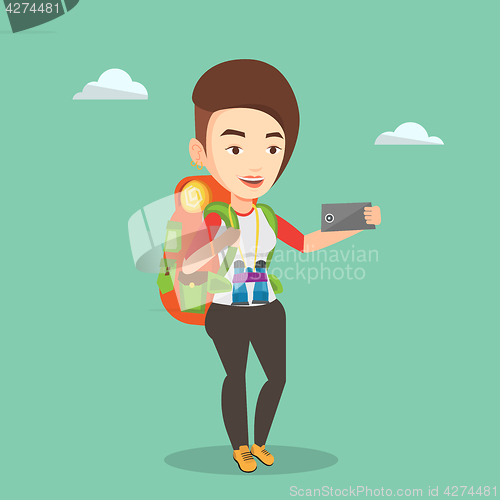 Image of Woman with backpack making selfie.