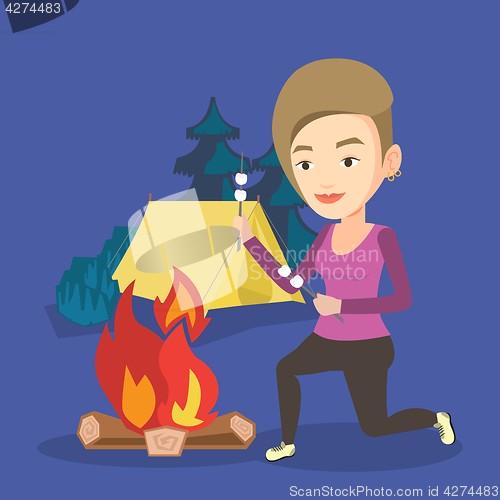 Image of Woman roasting marshmallow over campfire.