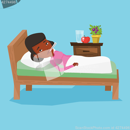 Image of Sick woman with thermometer laying in bed.