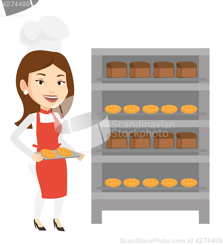 Image of Happy young female baker holding tray of bread.