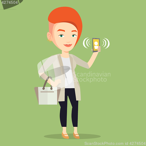 Image of Woman holding ringing mobile phone.