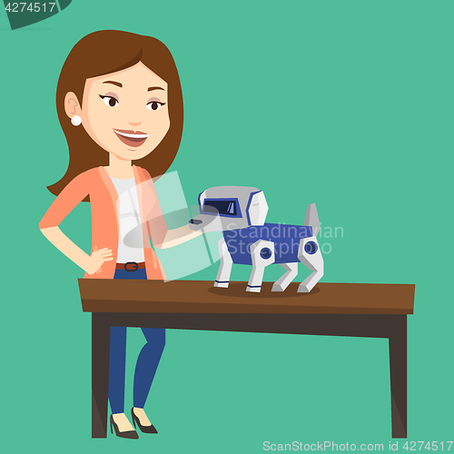 Image of Happy young woman playing with robotic dog.