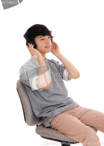 Image of Asian man listen head phone.