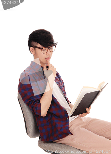 Image of Closeup of Asian man reading a book.