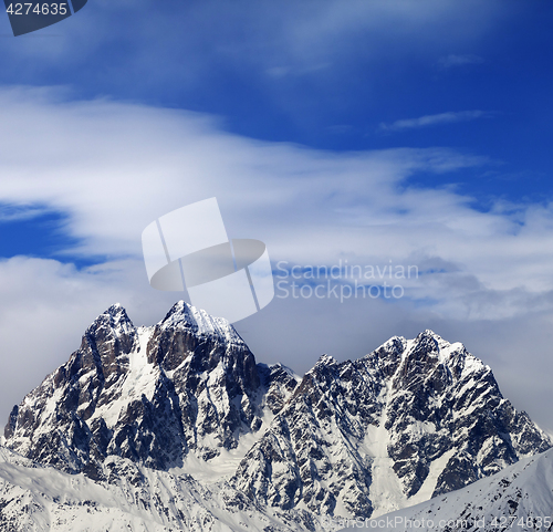 Image of Mounts Ushba and Chatyn and blue sky with clouds