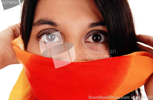 Image of Closeup of woman's eyes, mouth covered.