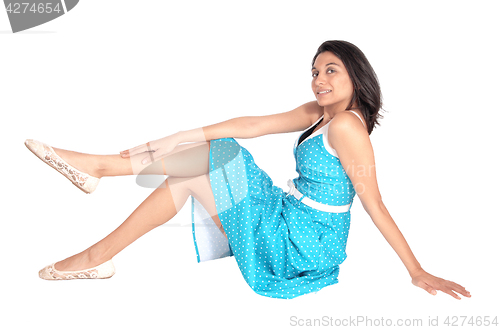 Image of Gorgeous woman sitting on floor.
