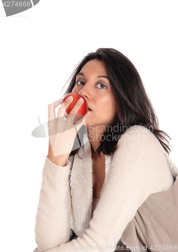 Image of Woman eating red apple.