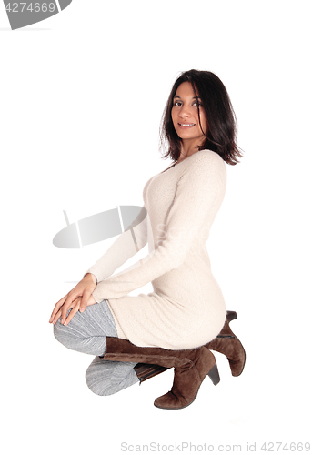 Image of Happy Hispanic woman kneeling.