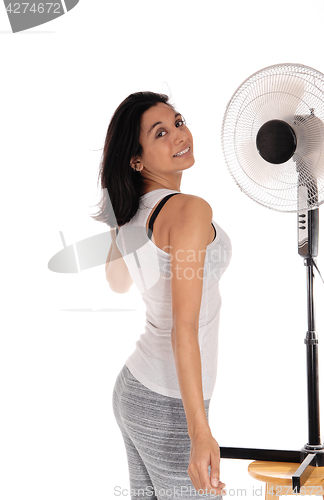 Image of Woman cooling up on fan.