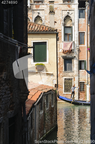 Image of Ancient buildings and a gondola on the canal in Venice, Veneto, 