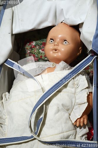 Image of old vintage doll in a stroller