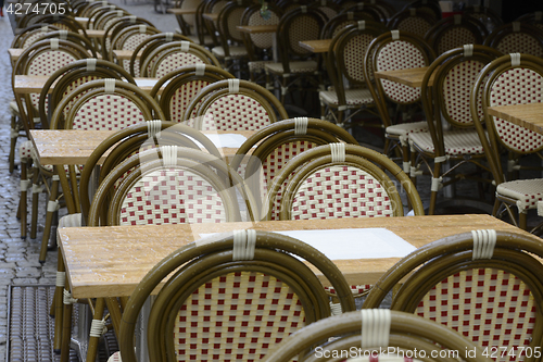 Image of empty coffee tables in the rain