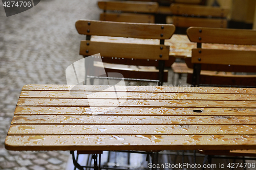 Image of empty coffee tables in the rain