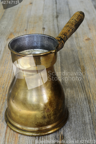 Image of old arabic coffee pot on wooden background