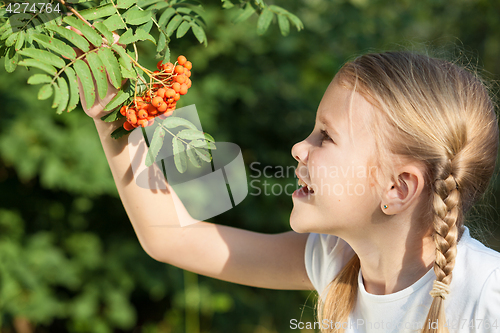 Image of portrait of a beautiful young girl  in park