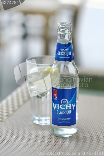 Image of carbonated water in glass bottle on the table