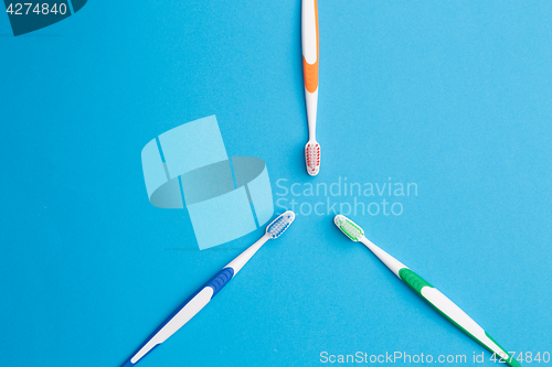 Image of Three toothbrushes on empty background