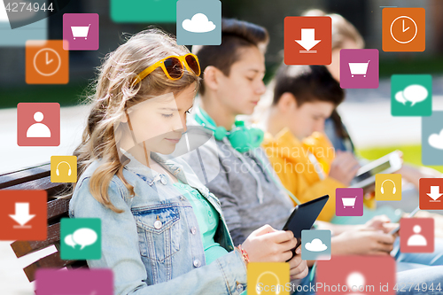 Image of happy teenage friends with tablet pc outdoors