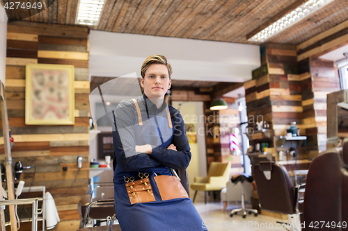 Image of male hairdresser at hair salon or barbershop