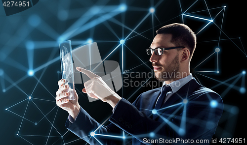 Image of businessman working with transparent tablet pc