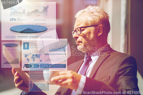 Image of senior businessman with tablet pc drinking coffee