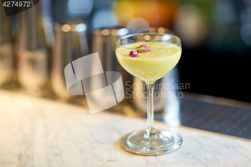 Image of glass of cocktail at bar