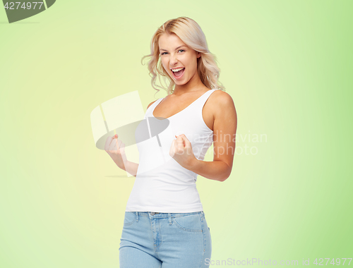 Image of happy young woman doing fist pump gesture