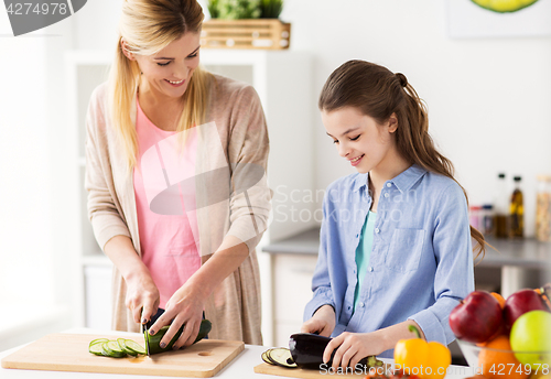 Image of happy family cooking dinner at home kitchen