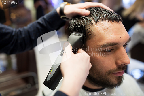 Image of man and barber hands with trimmer cutting hair