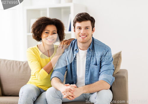 Image of happy smiling international couple at home