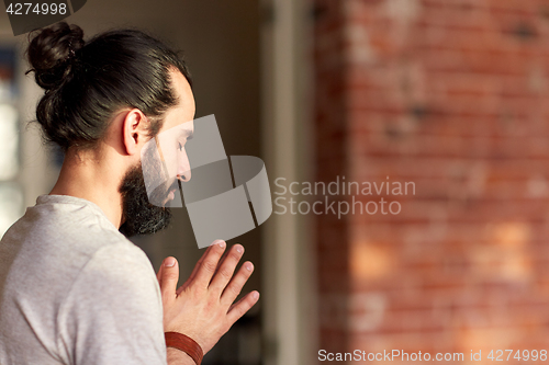 Image of close up of man meditating at yoga studio