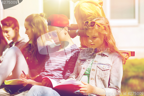 Image of group of students with notebooks at school yard