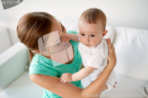 Image of happy young mother with little baby at home