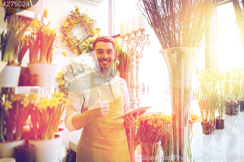 Image of man with tablet pc computer at flower shop