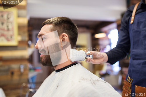 Image of barber with brush cleaning male neck at barbershop