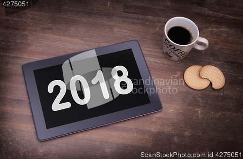 Image of Tablet touch computer gadget on wooden table - 2018