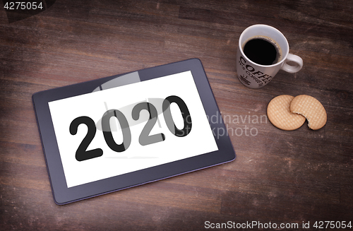 Image of Tablet touch computer gadget on wooden table - 2020