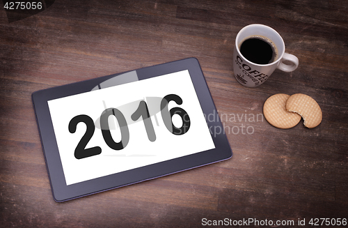 Image of Tablet touch computer gadget on wooden table - 2016