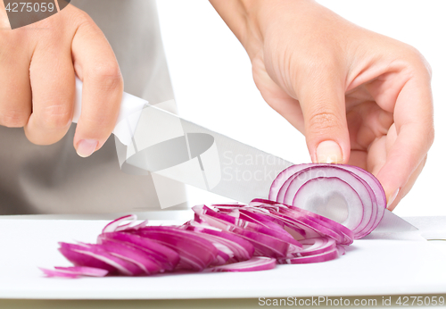 Image of Cook is chopping onion