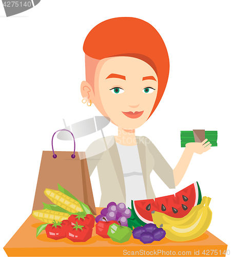 Image of Woman standing at the table with shopping bag.