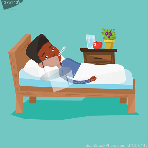 Image of Sick man with thermometer laying in bed.