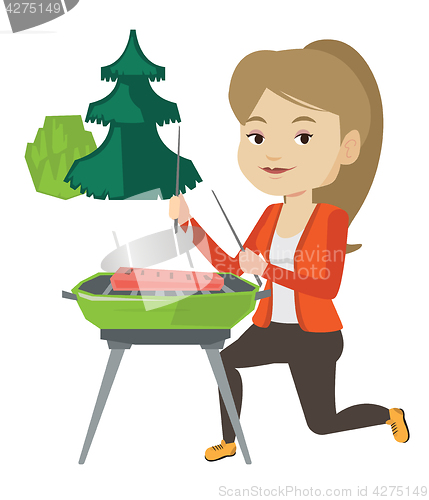 Image of Woman cooking steak on barbecue grill.