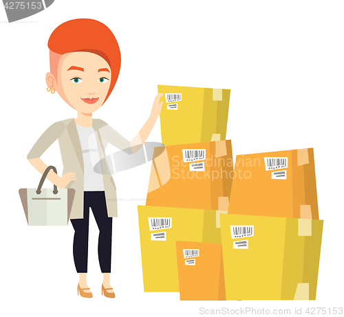 Image of Business woman checking boxes in warehouse.