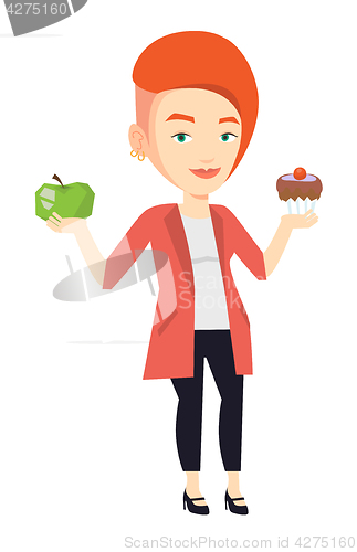 Image of Woman choosing between apple and cupcake.