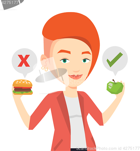 Image of Woman choosing between hamburger and cupcake.